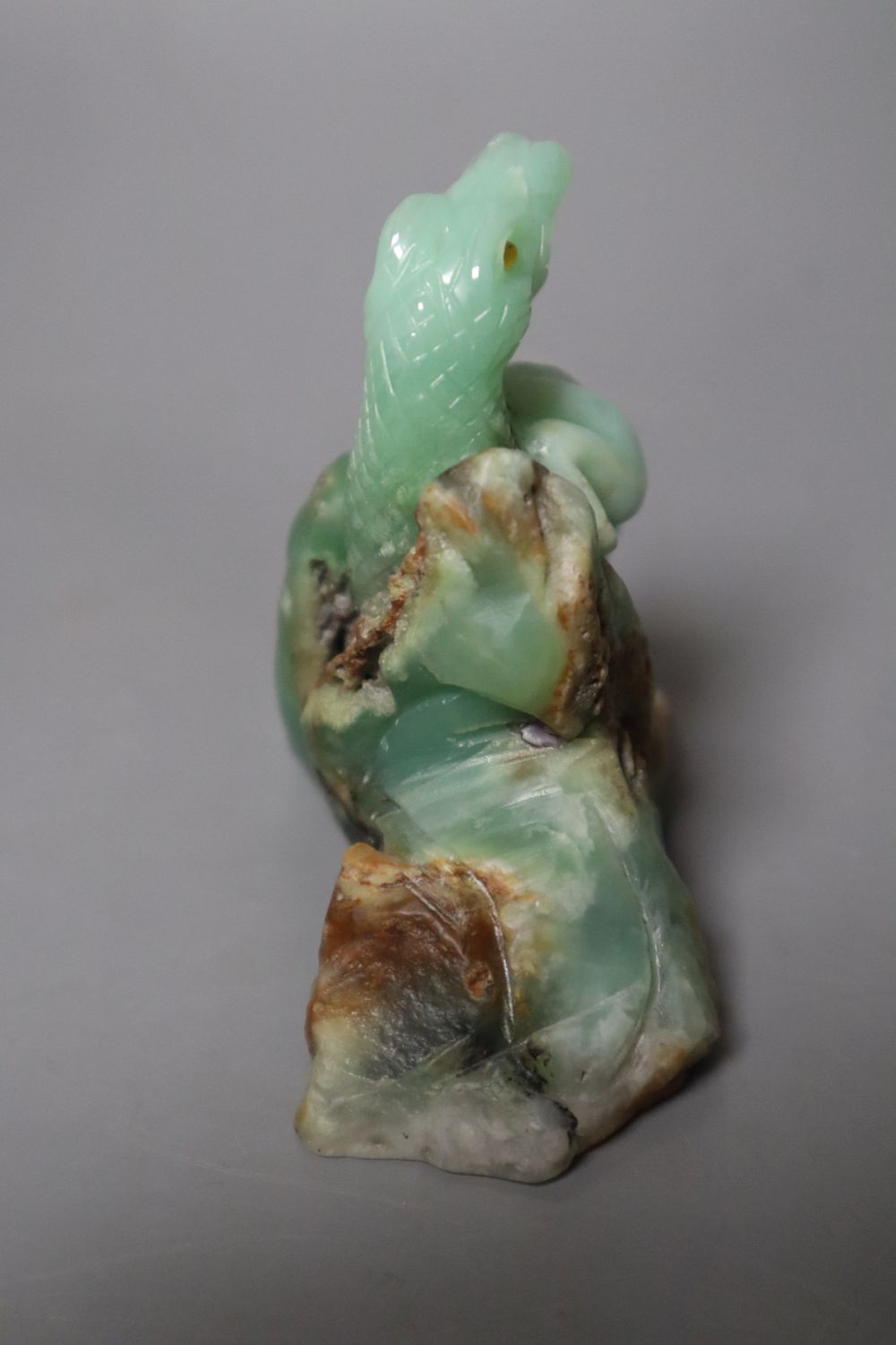 A Chinese jadeite carving of a toad and a serpent, 7.1cm high, with glass and lapis lazuli inset eyes